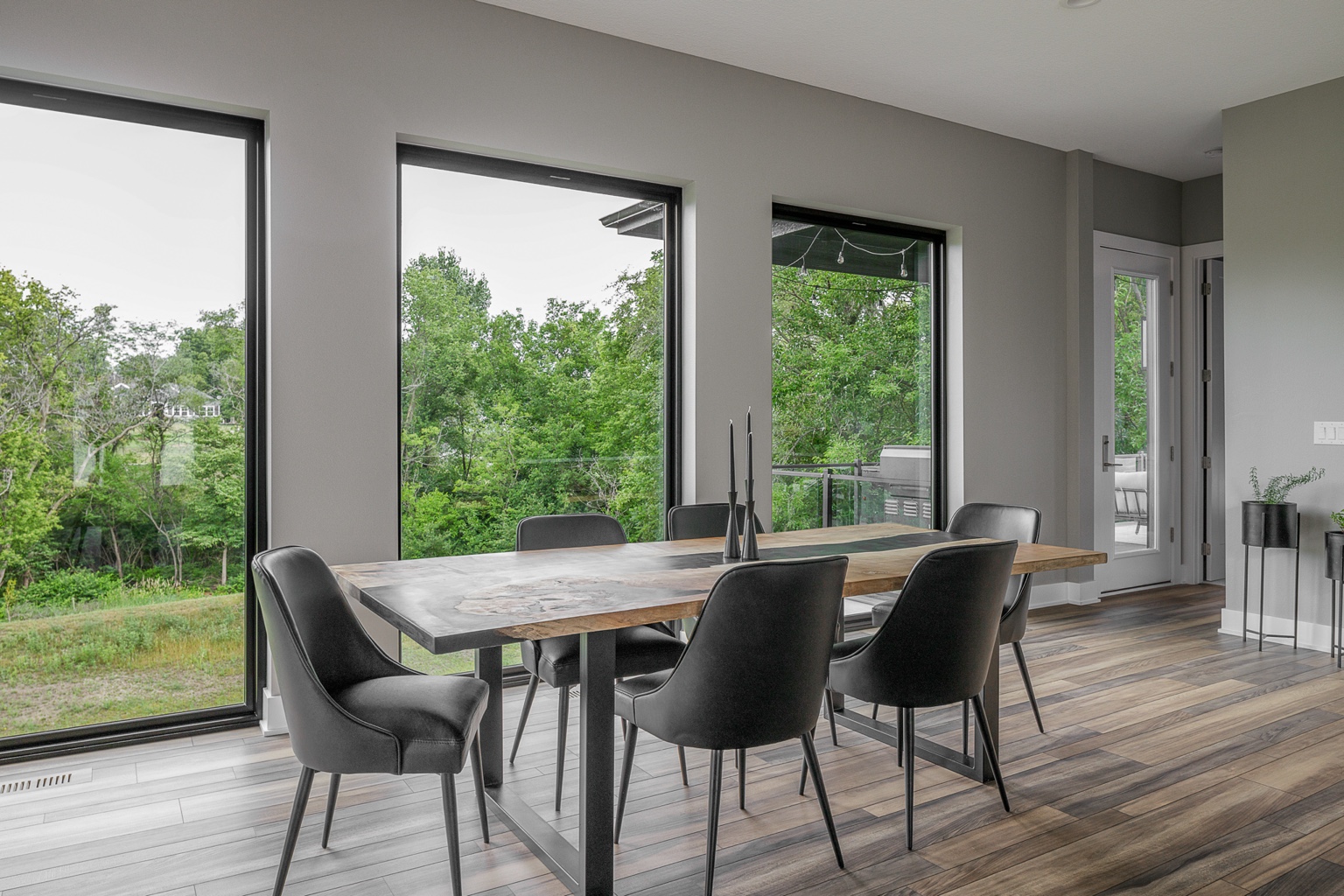 Dining space framed by large windows